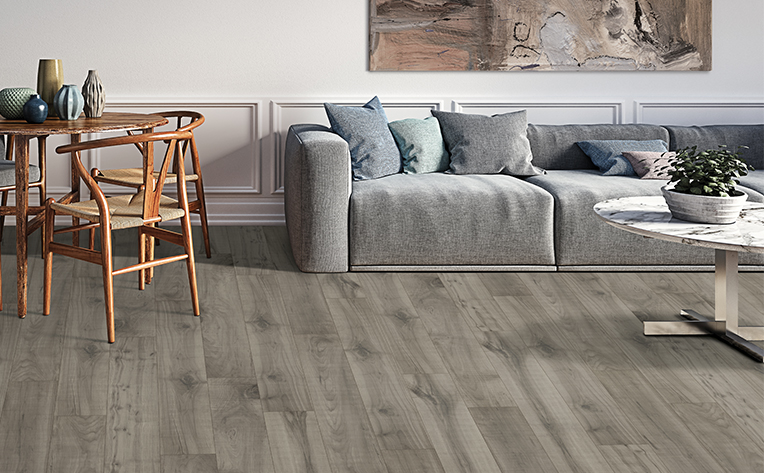 grey laminate flooring in living area with grey couch